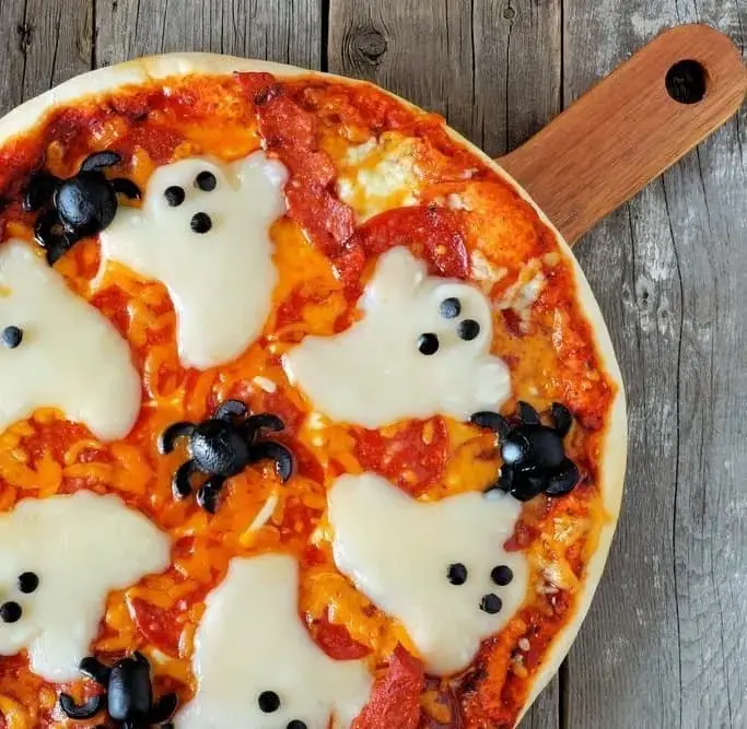 This is a round while pizza with mozzarella cheese circled around the circumference of the dish. 
