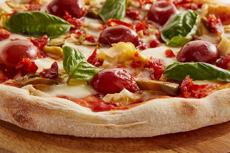This image shows the roundness of the pizza with a clear view of the different toppings.
